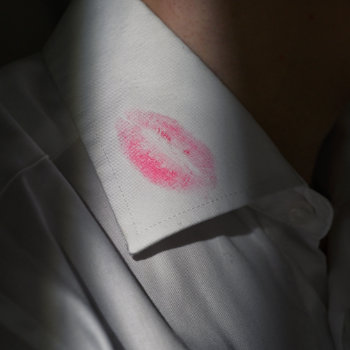 Lipstick mark on a white shirt collar.